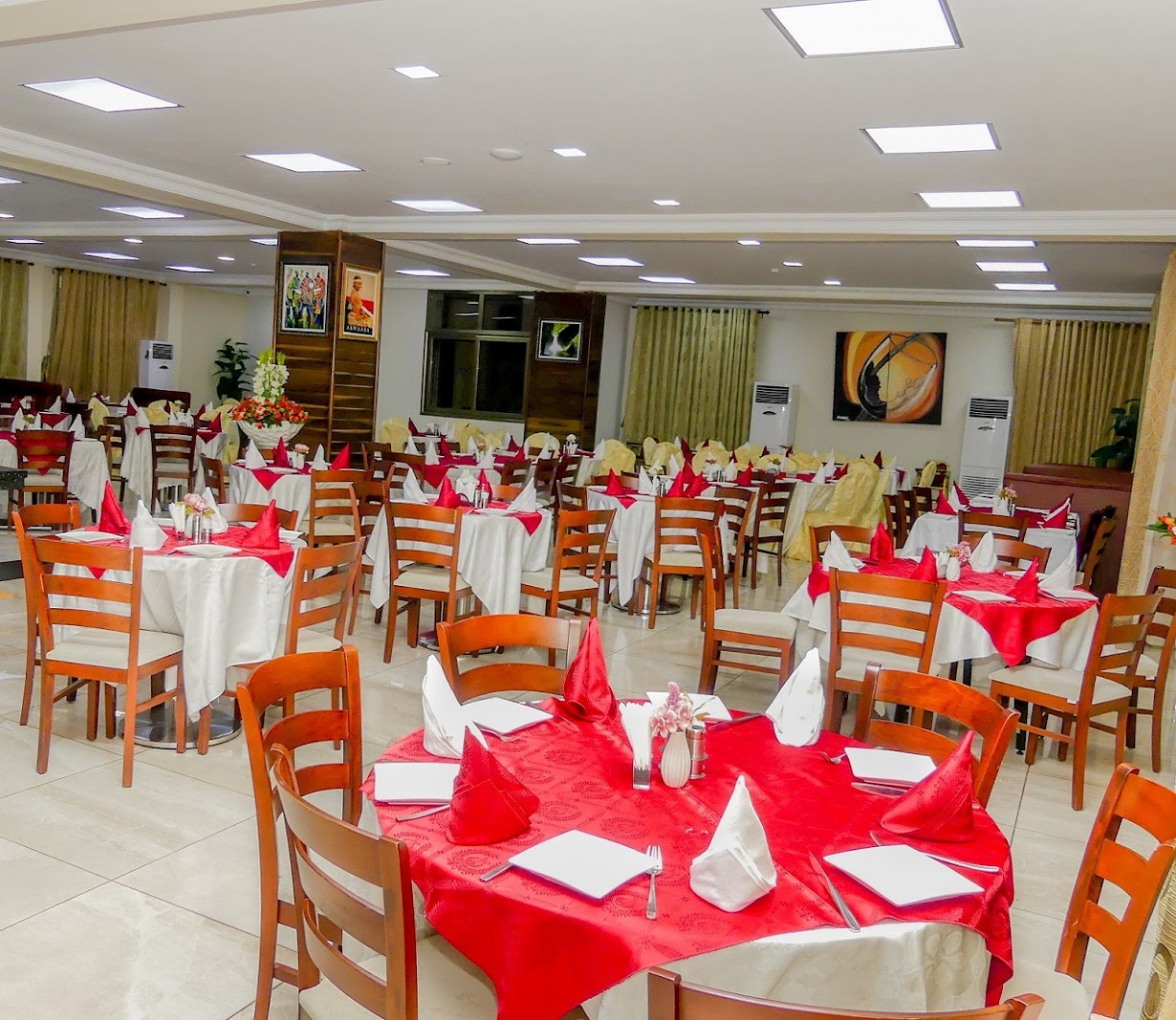 The hotel restaurant set with white and red linens