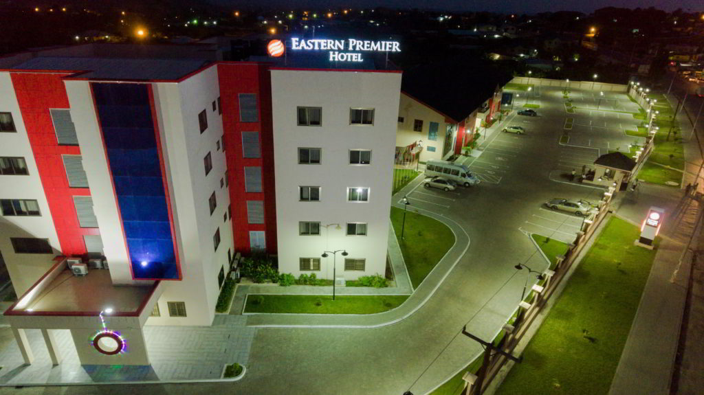 Night view of the hotel with its illuminated rooftop sign